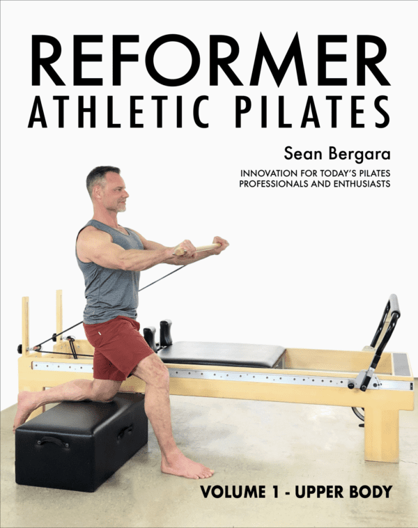 Reformer Athlestic Pilates Cover - Sean Bergara is using a pilates machine, and is in a lunge, using a block to help support the pose