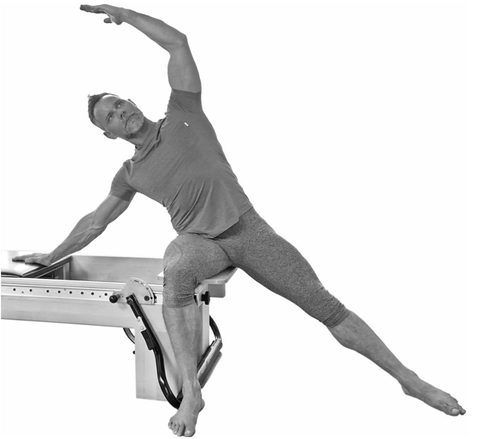 Sean Bergara stretching using a pilates machine